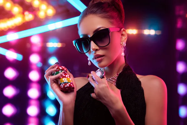 A young woman relaxing with her phone while dynamic casino elements float around her, illustrating the smooth mobile experience offered by the A177 app.